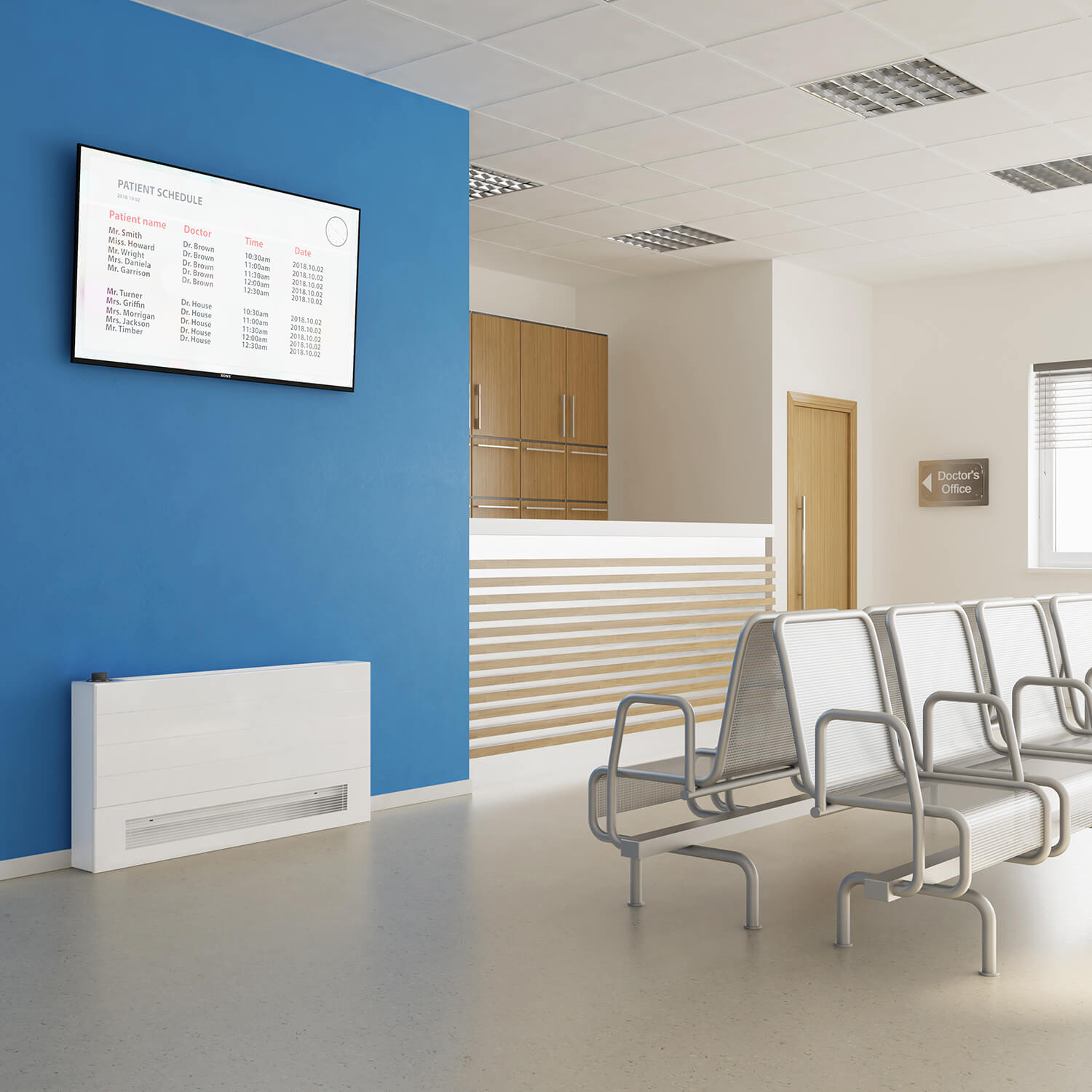 Stelrad white low surface temperature radiator against a blue wall in a doctor's waiting room